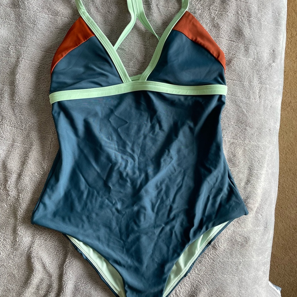 Never worn prAna multi colored one piece, cheeky cut size S